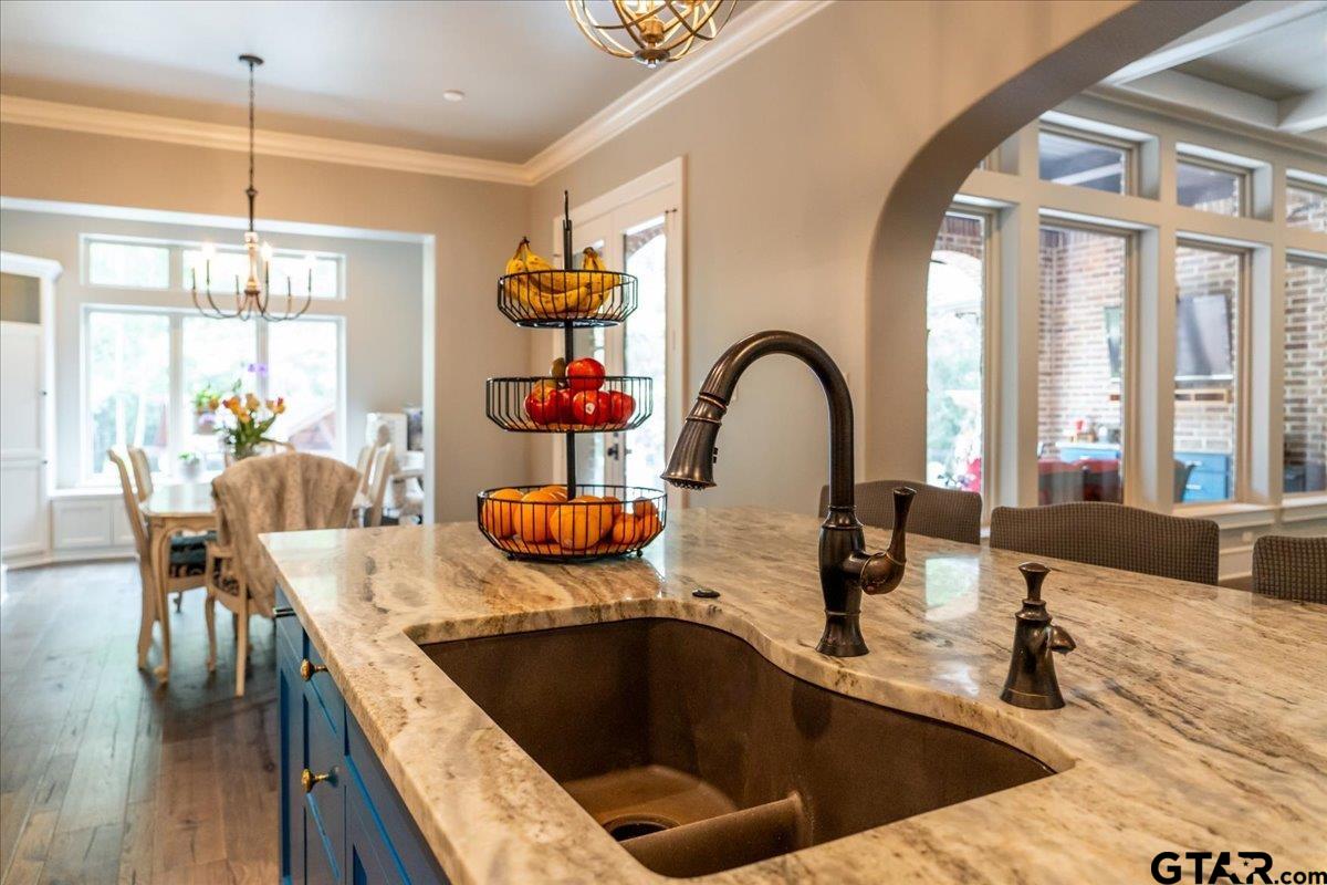 6527 Rochester Way Tyler, TX 75703 - Photo 9 of 48 a kitchen with a sink a counter and chairs