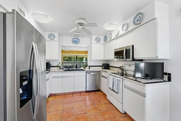 a view of a dining room with furniture large windows and wooden floor