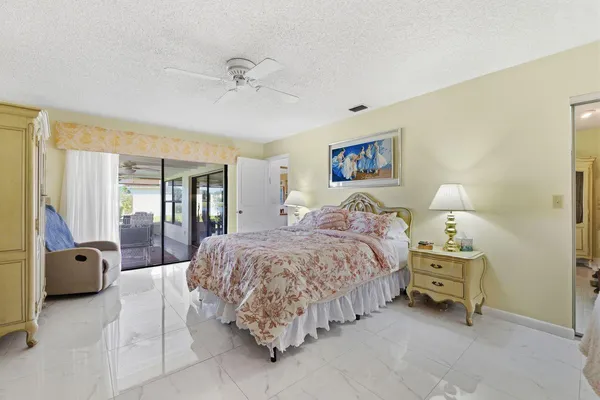 a bedroom with a bed and chair