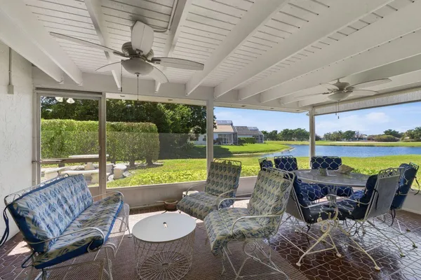 a view of a house with pool and chairs
