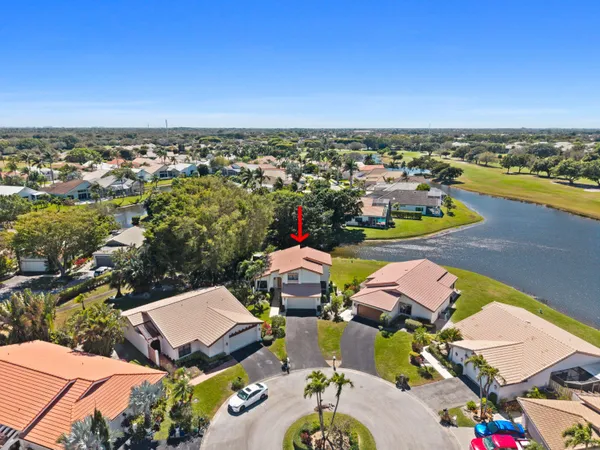 a front view of yellow house with a yard
