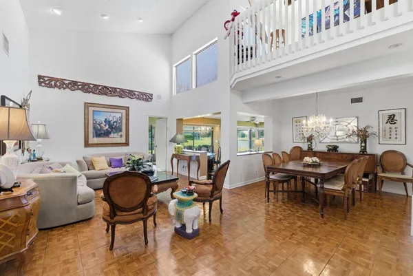 a view of a dining room with furniture and chandelier