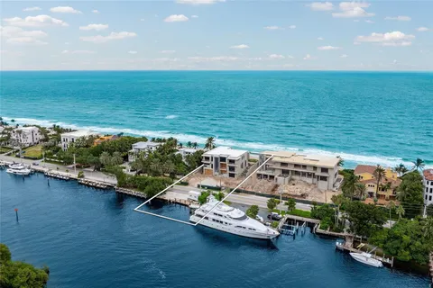 an aerial view of a house with outdoor space and lake view in back