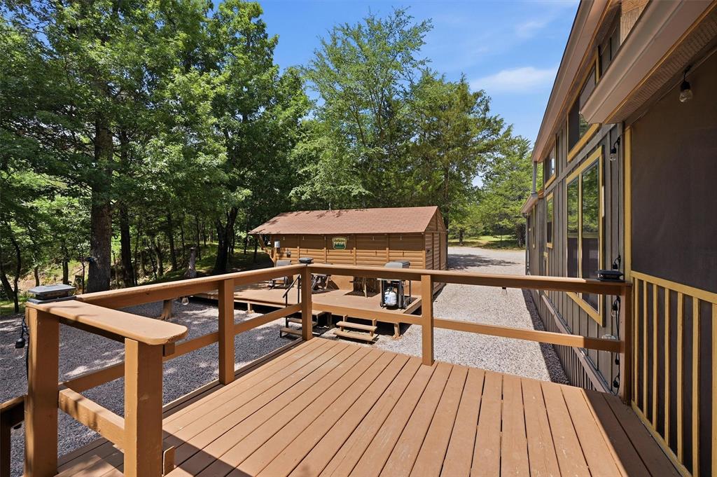 3958 Ranch Road Whitesboro, TX 76273 - Photo 22 of 40 Expansive wood-finish decking with railings