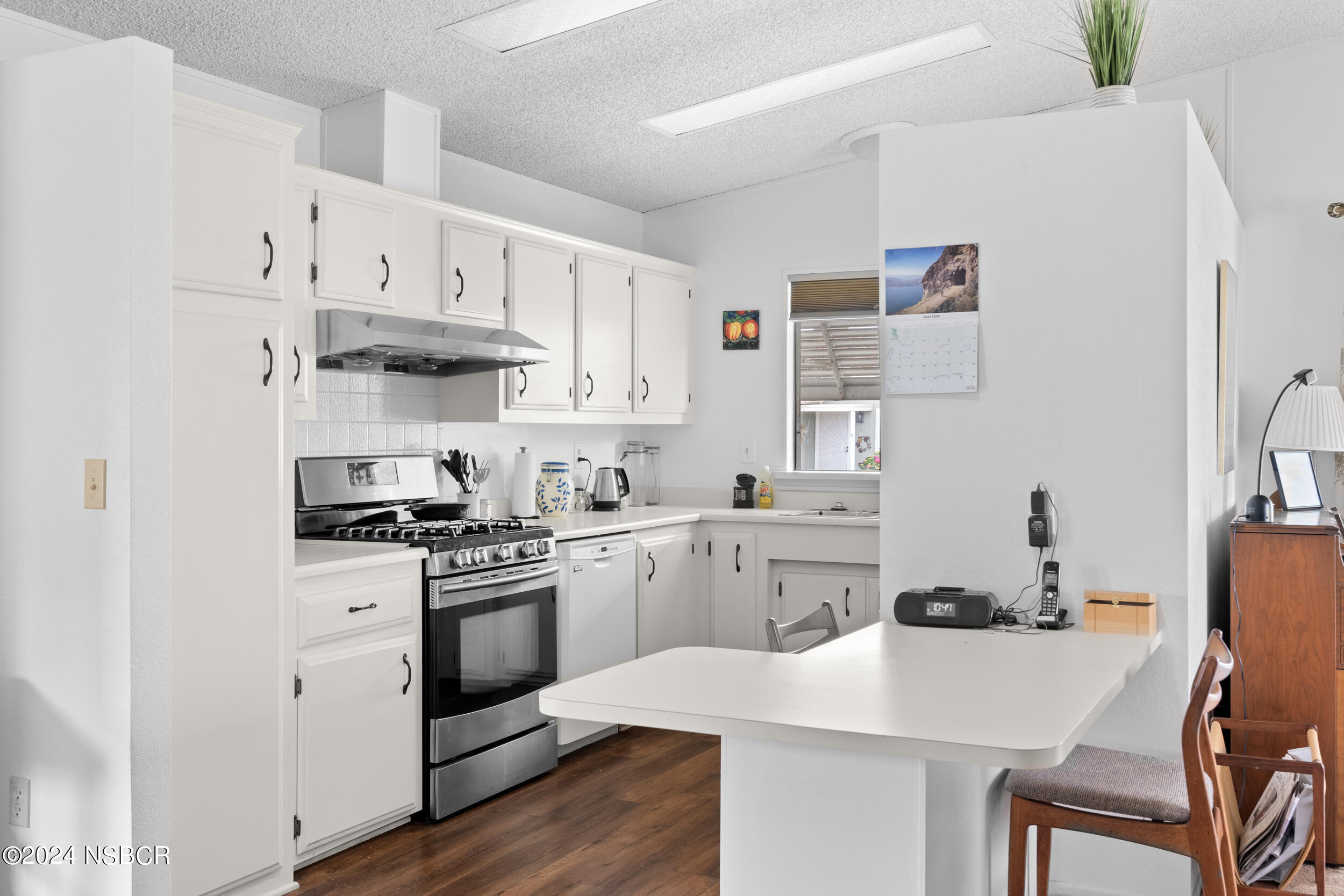 961 North Ridge View Drive Santa Maria, CA 93455 - Photo 12 of 37 a kitchen with white cabinets and white appliances