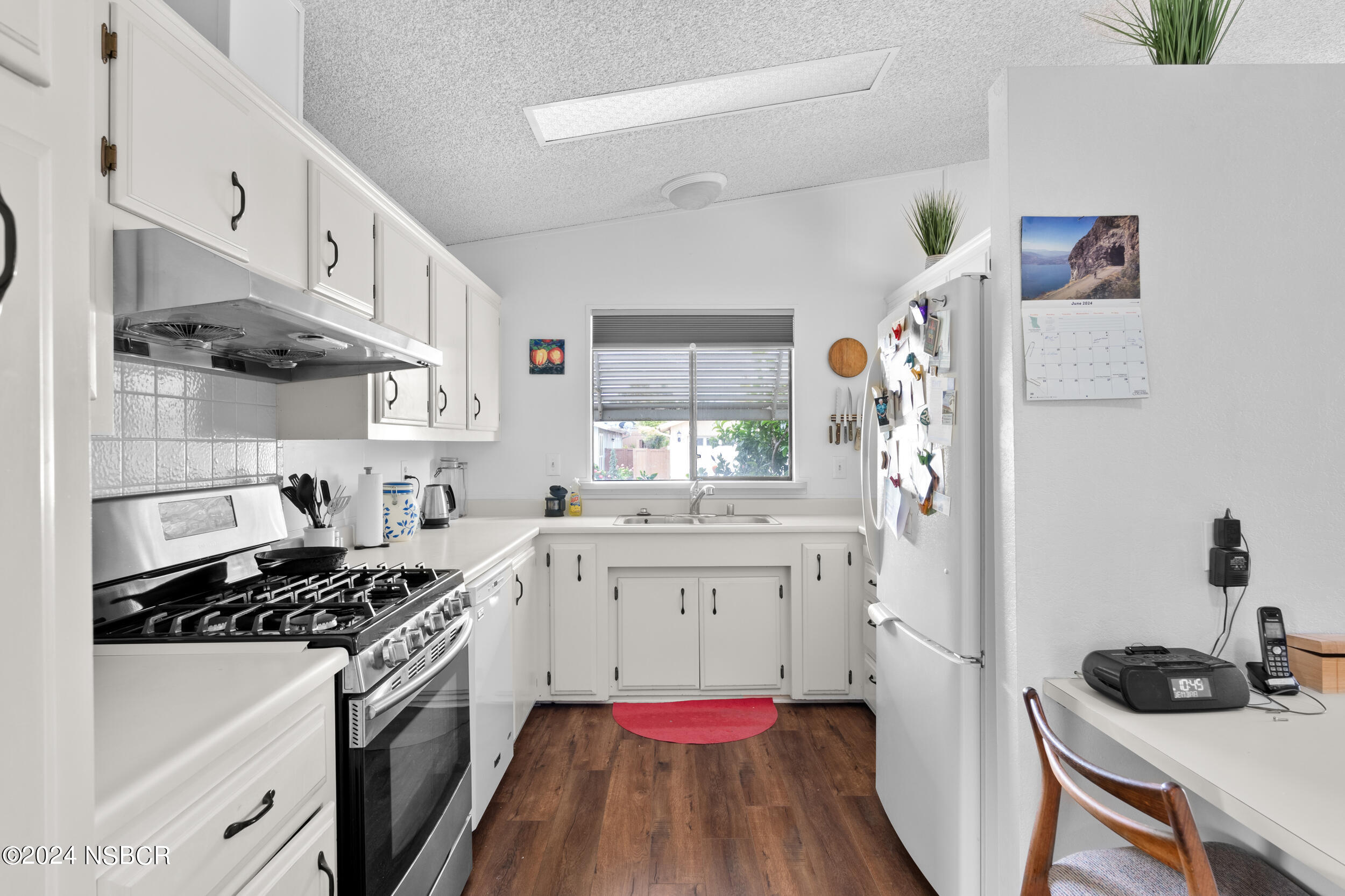 961 North Ridge View Drive Santa Maria, CA 93455 - Photo 13 of 37 a kitchen with a stove a sink and a refrigerator