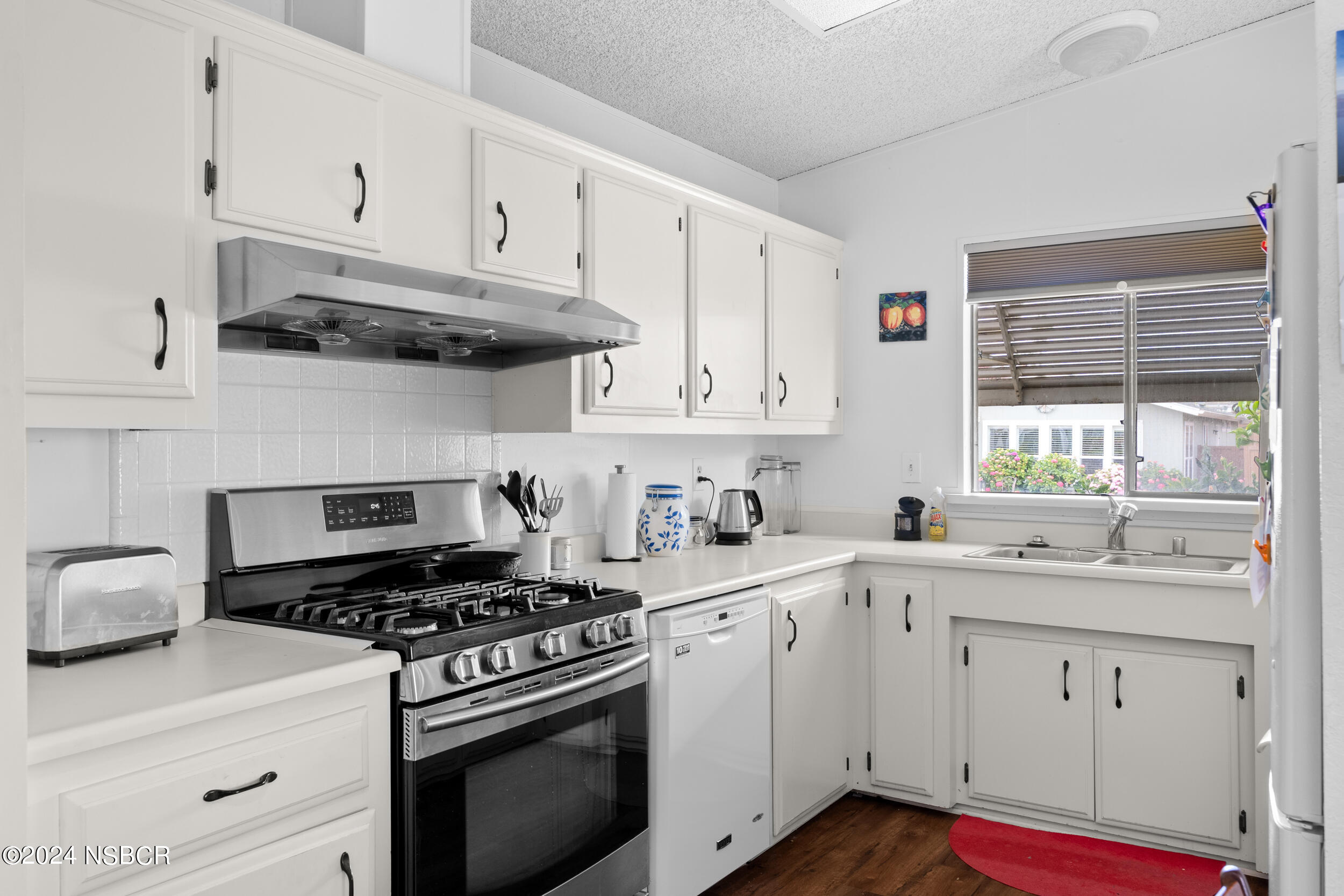 961 North Ridge View Drive Santa Maria, CA 93455 - Photo 14 of 37 a kitchen with cabinets appliances a sink and a window