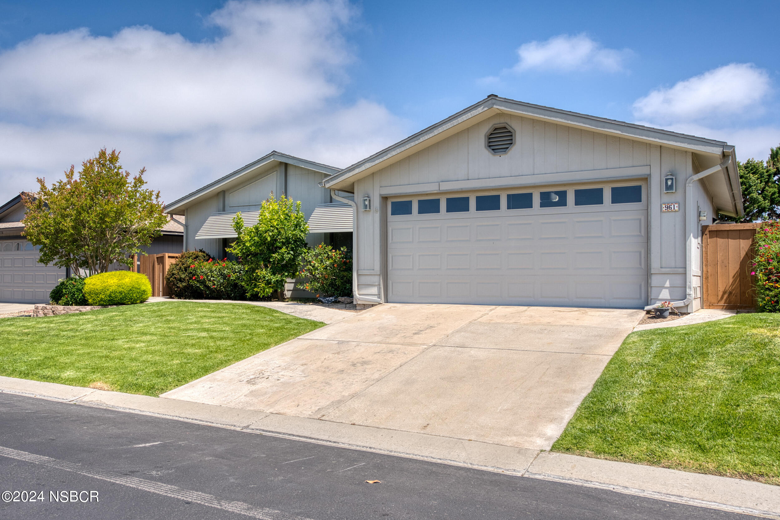 961 North Ridge View Drive Santa Maria, CA 93455 - Photo 3 of 37 a front view of a house with a yard and garage