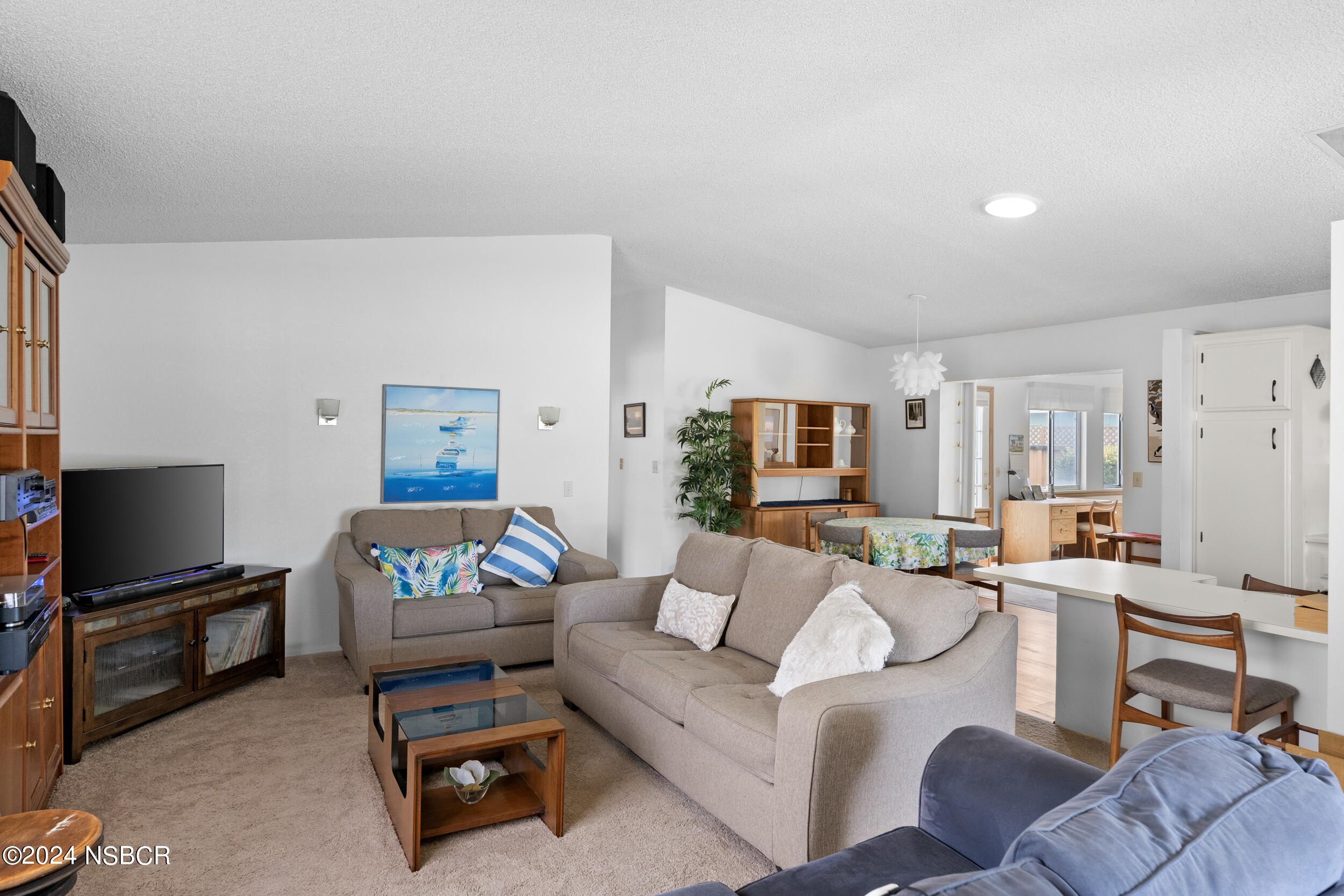961 North Ridge View Drive Santa Maria, CA 93455 - Photo 7 of 37 a living room with furniture a flat screen tv and a window
