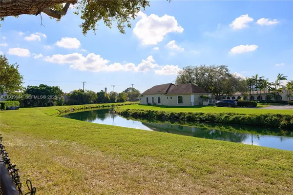 a view of a lake in front of house with a yard