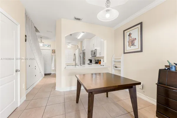 a kitchen with stainless steel appliances a table and chairs