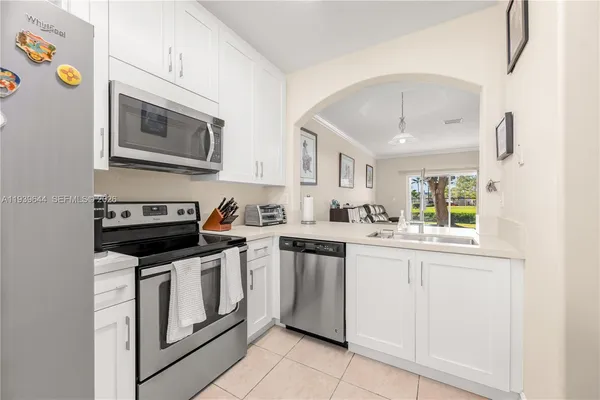a kitchen with stainless steel appliances granite countertop a stove and a microwave