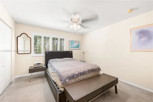 a bedroom with a bed and a table with closet