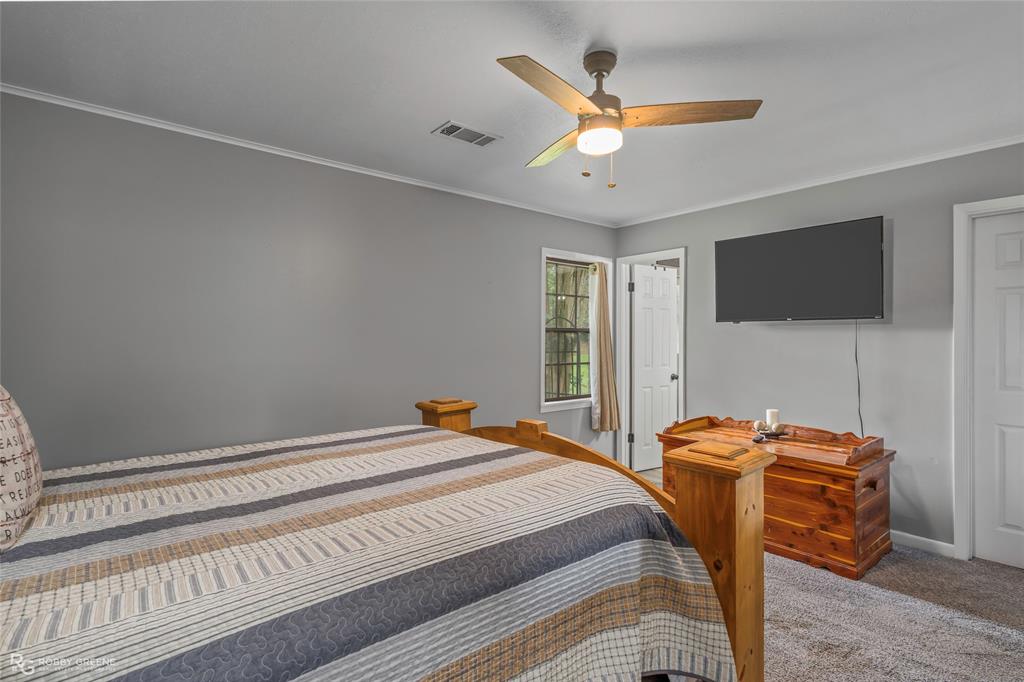 1426 Caney Lake Road Minden, LA 71055 - Photo 14 of 36 Carpeted bedroom with neutral gray walls and white trim