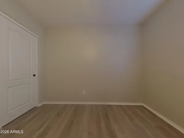 a view of a small space with wooden floor and a window