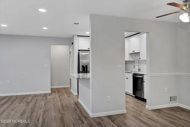 a view of kitchen view wooden floor and a sink