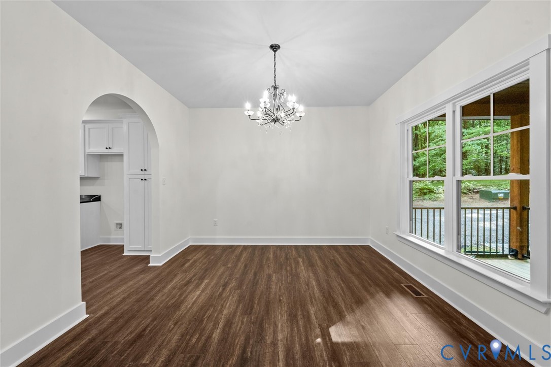 4062 Lake Killarney Road Gum Spring, VA 23065 - Photo 15 of 37 a view of a room with wooden floor chandelier and windows