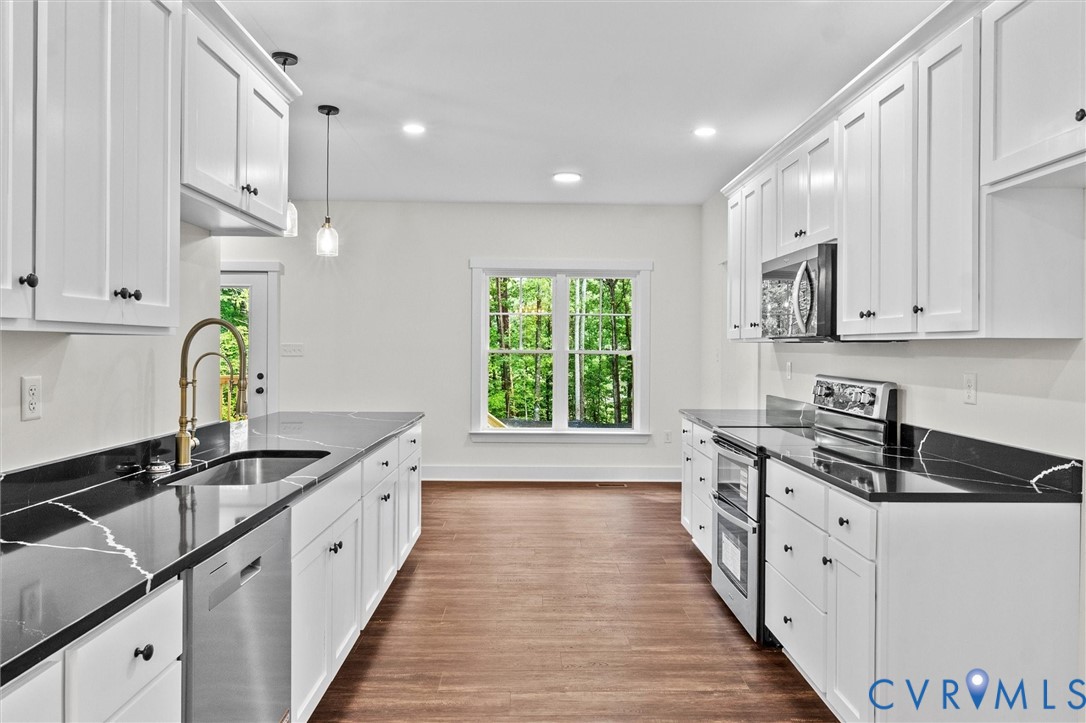 4062 Lake Killarney Road Gum Spring, VA 23065 - Photo 17 of 37 a kitchen with stainless steel appliances granite countertop a sink stove and cabinets