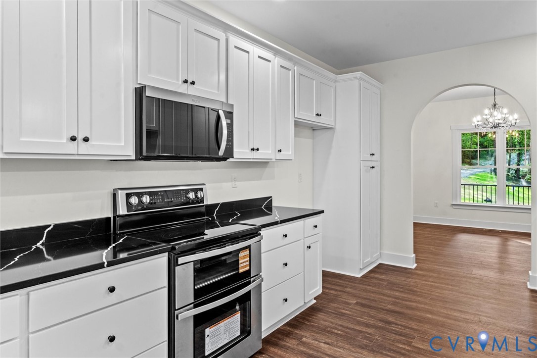 4062 Lake Killarney Road Gum Spring, VA 23065 - Photo 18 of 37 a kitchen with granite countertop white cabinets and stainless steel appliances