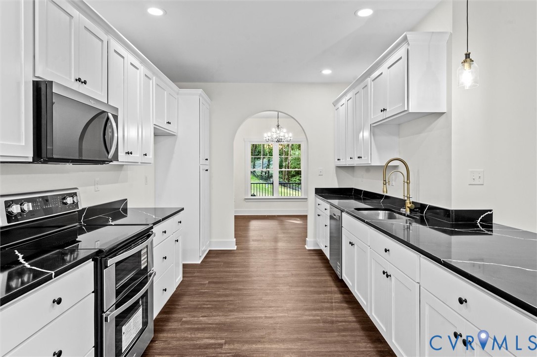 4062 Lake Killarney Road Gum Spring, VA 23065 - Photo 21 of 37 a large kitchen with stainless steel appliances granite countertop a stove and a sink