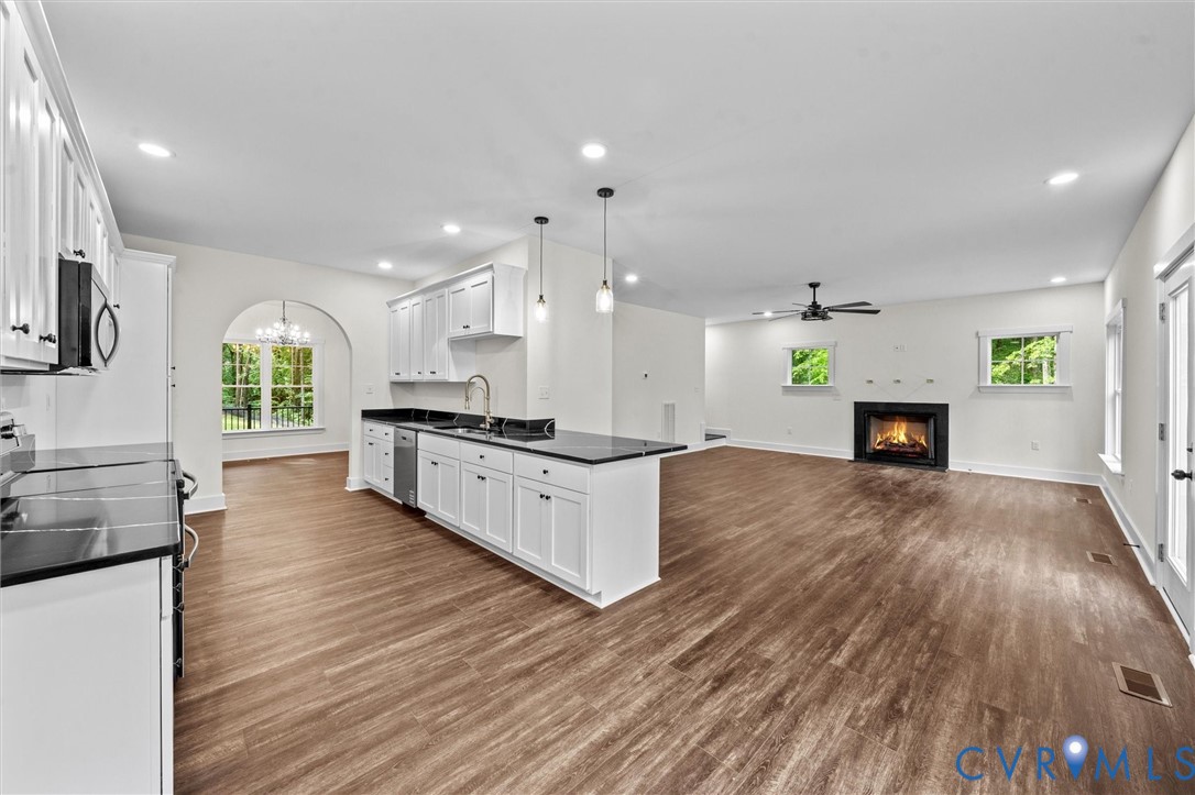 4062 Lake Killarney Road Gum Spring, VA 23065 - Photo 24 of 37 a large kitchen with cabinets wooden floor and stainless steel appliances