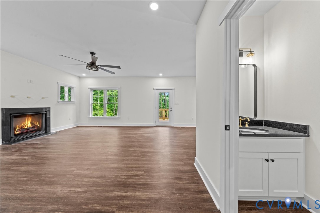 4062 Lake Killarney Road Gum Spring, VA 23065 - Photo 26 of 37 a view of an empty room with a window and wooden floor