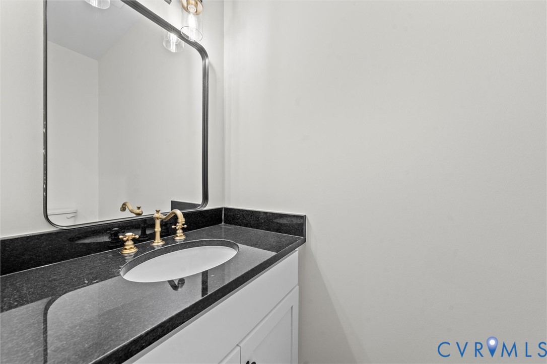 4062 Lake Killarney Road Gum Spring, VA 23065 - Photo 27 of 37 a bathroom with a granite countertop sink and a mirror