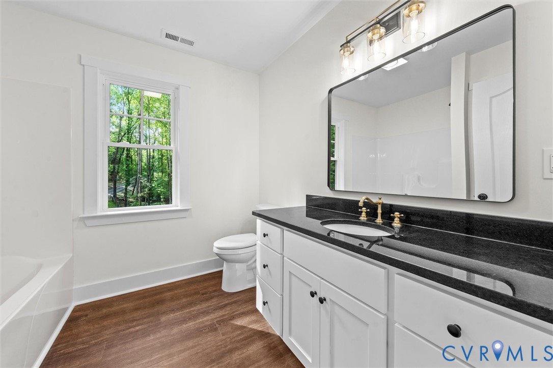 4062 Lake Killarney Road Gum Spring, VA 23065 - Photo 32 of 37 a bathroom with a toilet sink and mirror