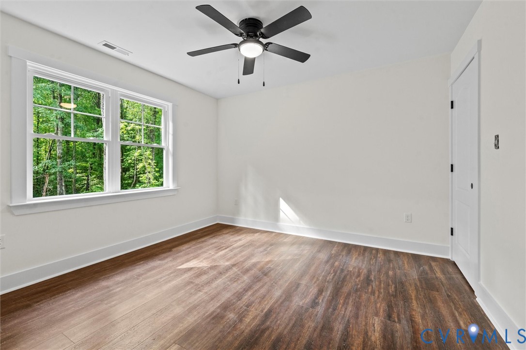 4062 Lake Killarney Road Gum Spring, VA 23065 - Photo 33 of 37 wooden floor in an empty room with a window