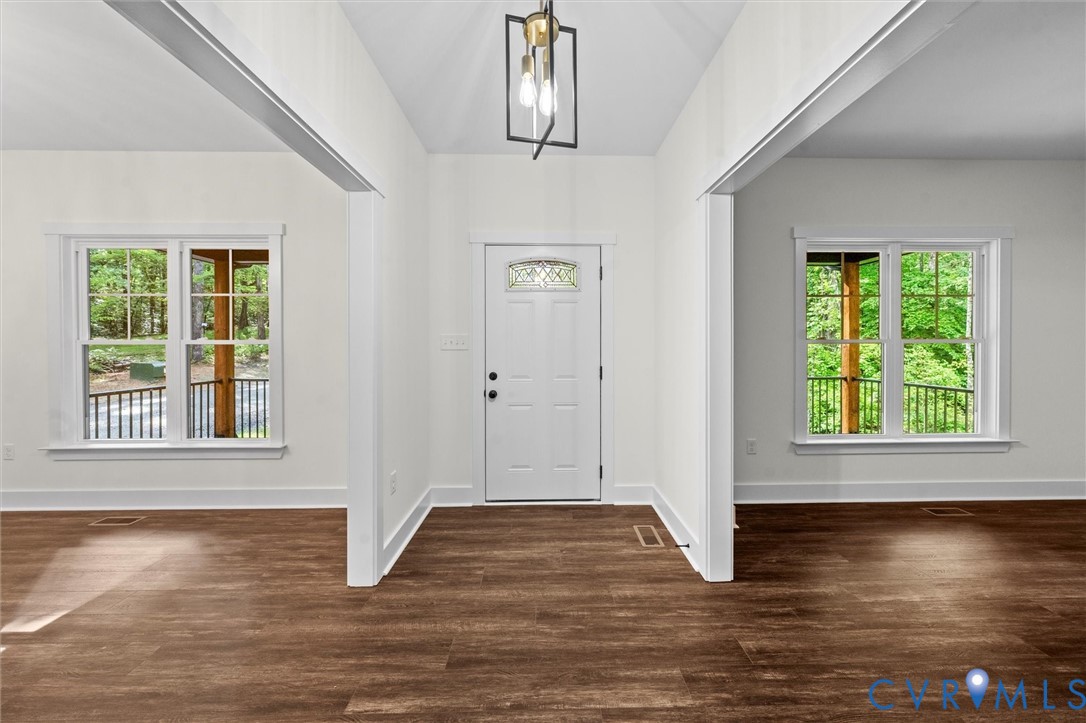 4062 Lake Killarney Road Gum Spring, VA 23065 - Photo 6 of 37 a view of an empty room with wooden floor and a window