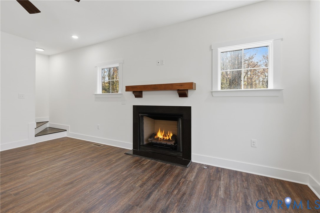 4062 Lake Killarney Road Gum Spring, VA 23065 - Photo 9 of 37 a living room with wooden floor and a fireplace