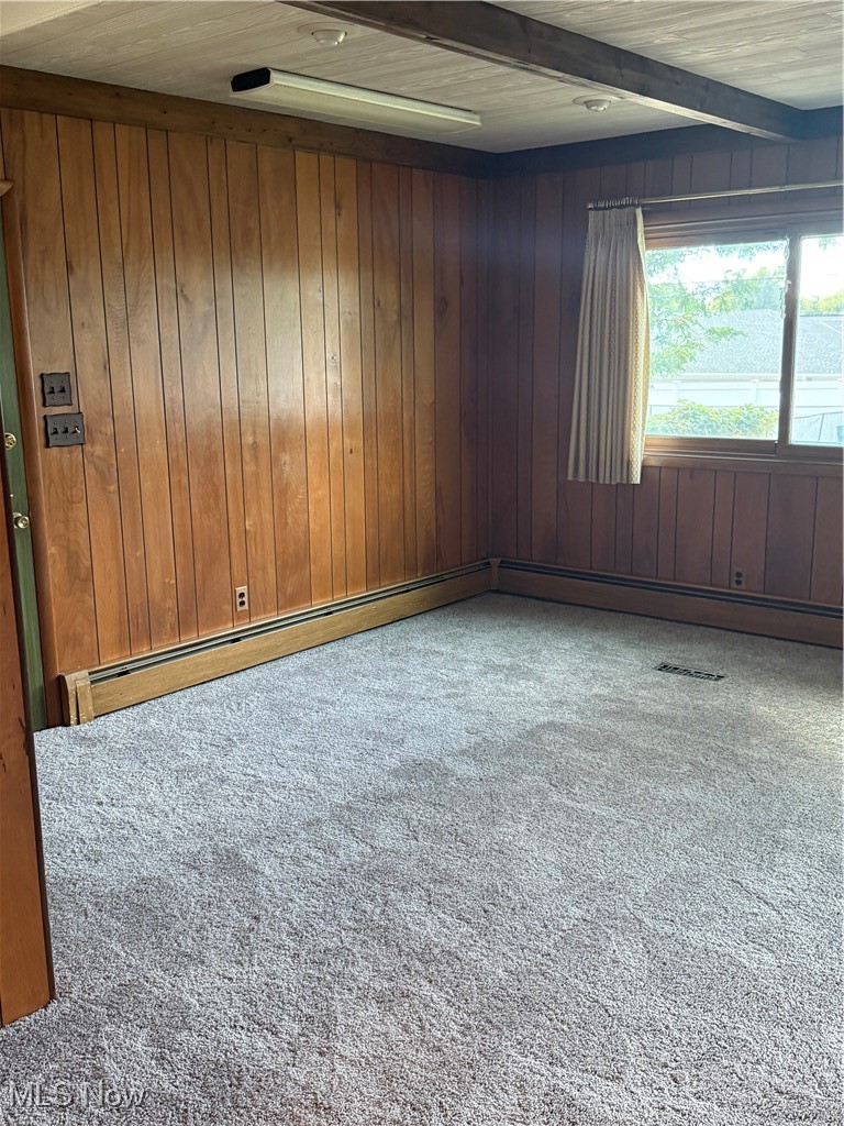 1284 Haverston Road Lyndhurst, OH 44124 - Photo 17 of 43 Carpeted spare room with baseboard heating, wooden walls, and beamed ceiling