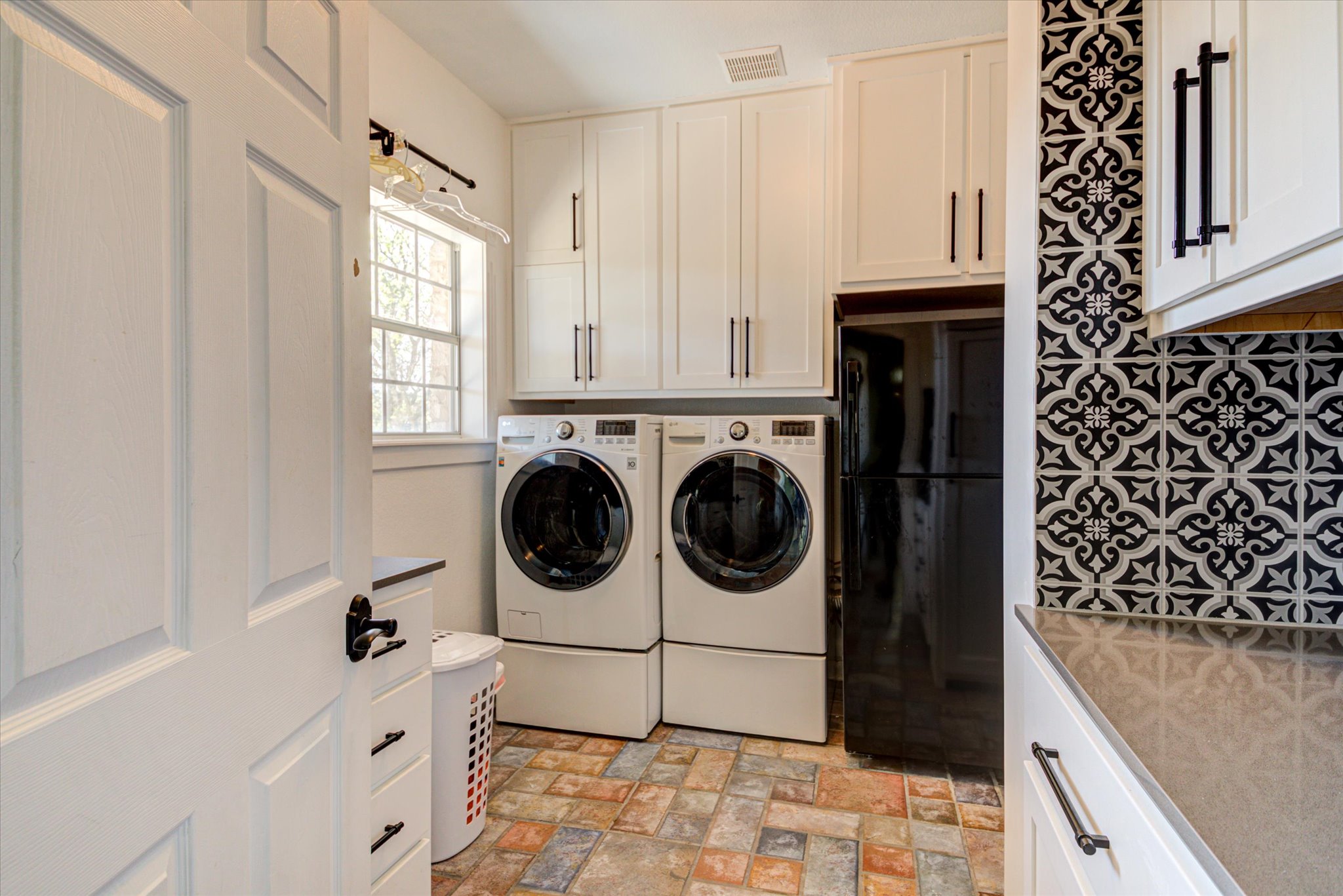 13423 Trail Driver Street Austin, TX 78737 - Photo 20 of 40 Beautiful utility room with custom cabinets and tile accents