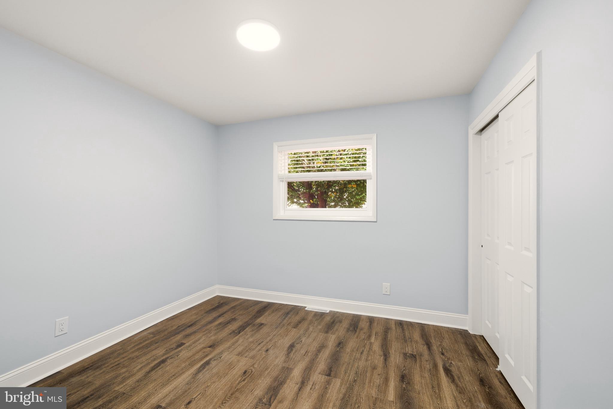 171 Juniper Road Havertown, PA 19083 - Photo 11 of 31 an empty room with wooden floor and windows