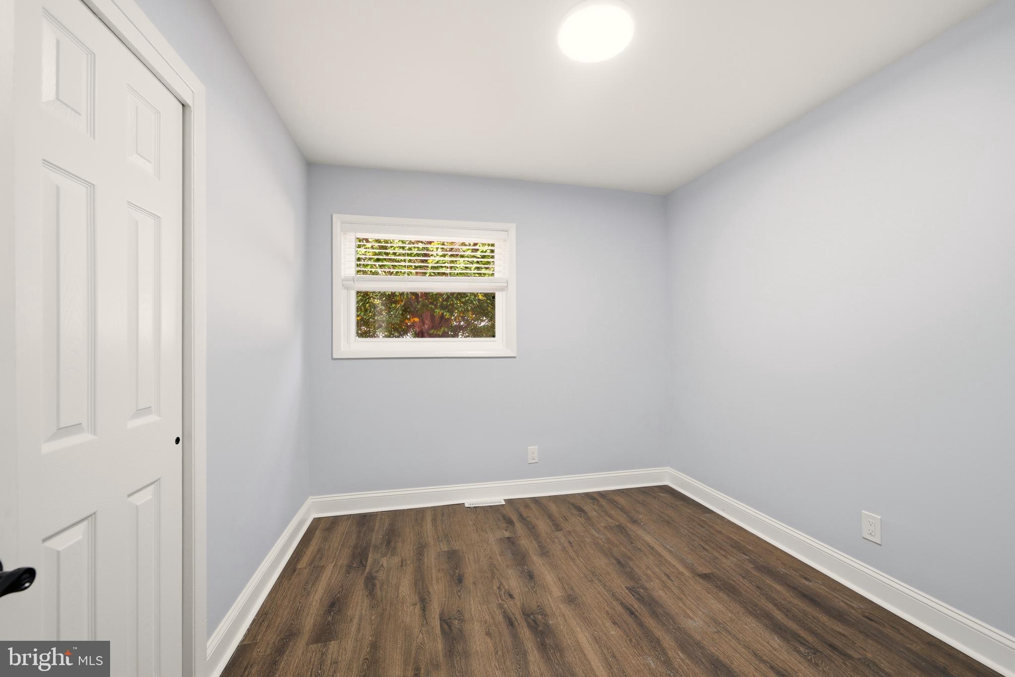 171 Juniper Road Havertown, PA 19083 - Photo 14 of 31 a view of an empty room with wooden floor and a window