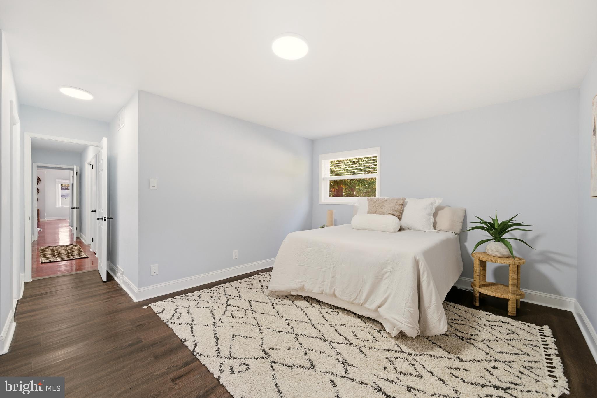 171 Juniper Road Havertown, PA 19083 - Photo 18 of 31 a bedroom with a large bed and a potted plant