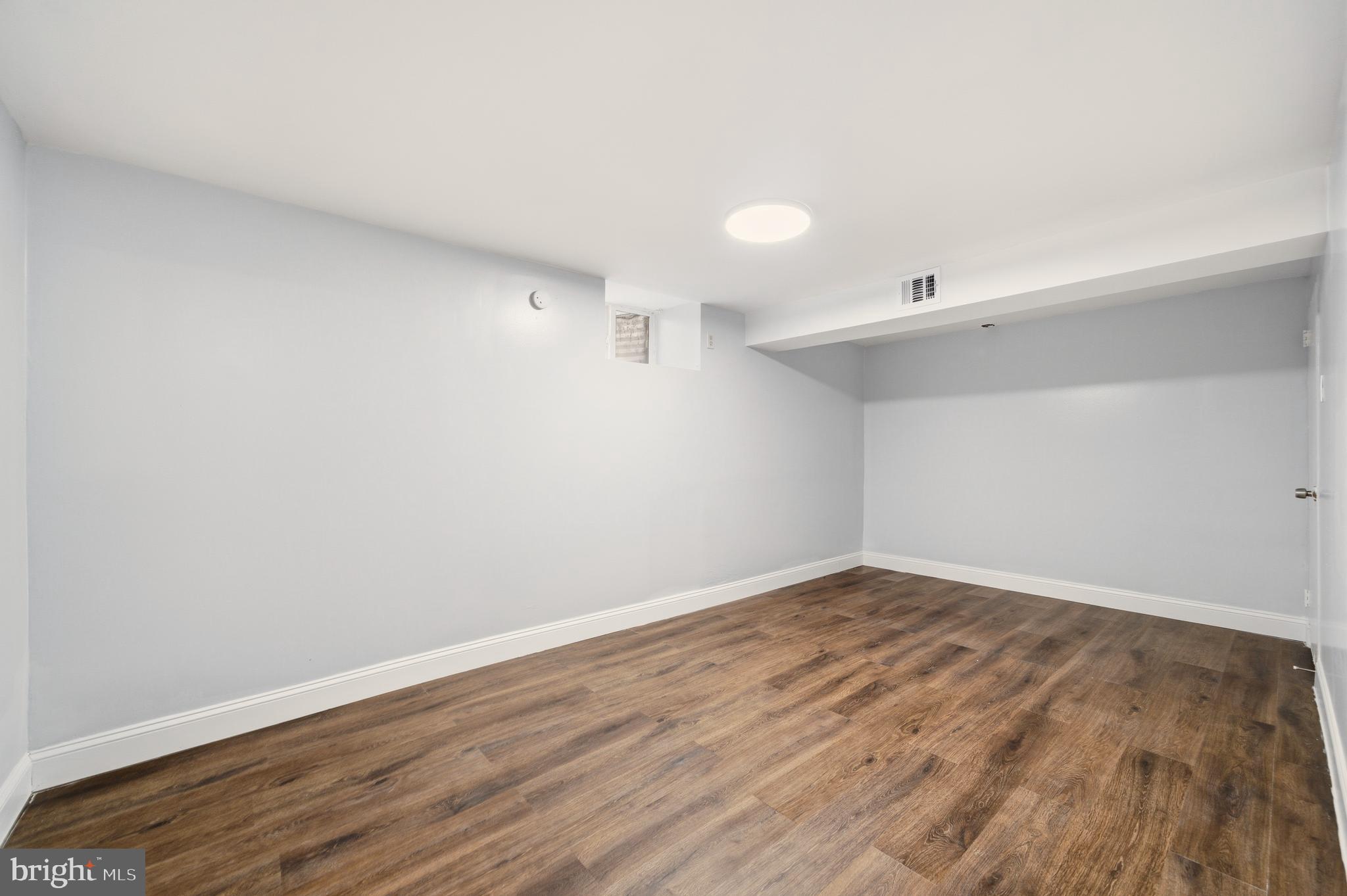 171 Juniper Road Havertown, PA 19083 - Photo 24 of 31 a view of an empty room with wooden floor and a window