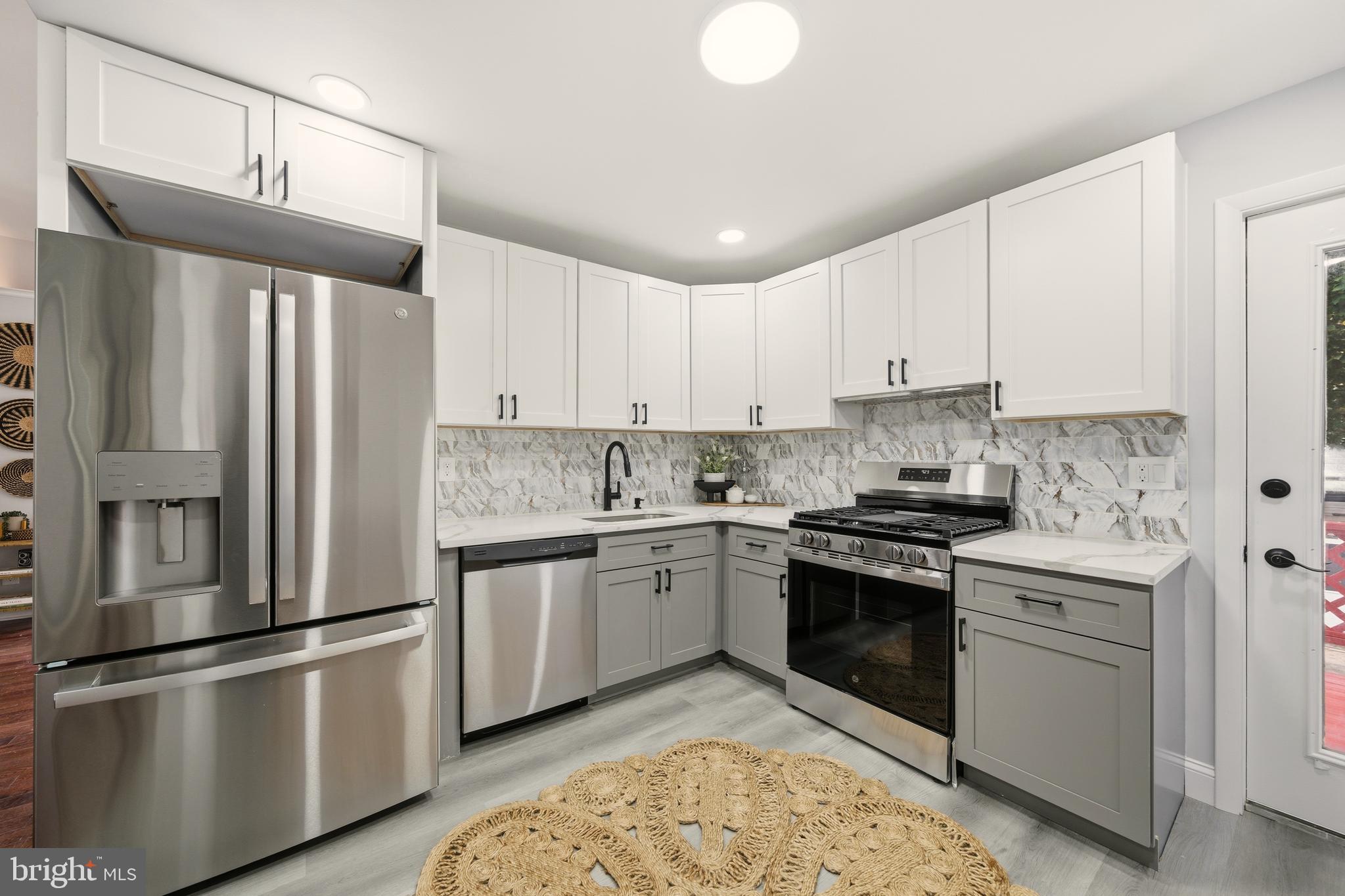 171 Juniper Road Havertown, PA 19083 - Photo 8 of 31 a kitchen with stainless steel appliances granite countertop a stove a refrigerator and a sink