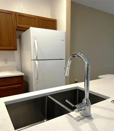 a kitchen with stainless steel appliances granite countertop a sink and a stove