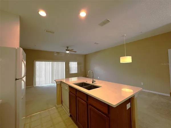 a view of a livingroom with a ceiling fan and window