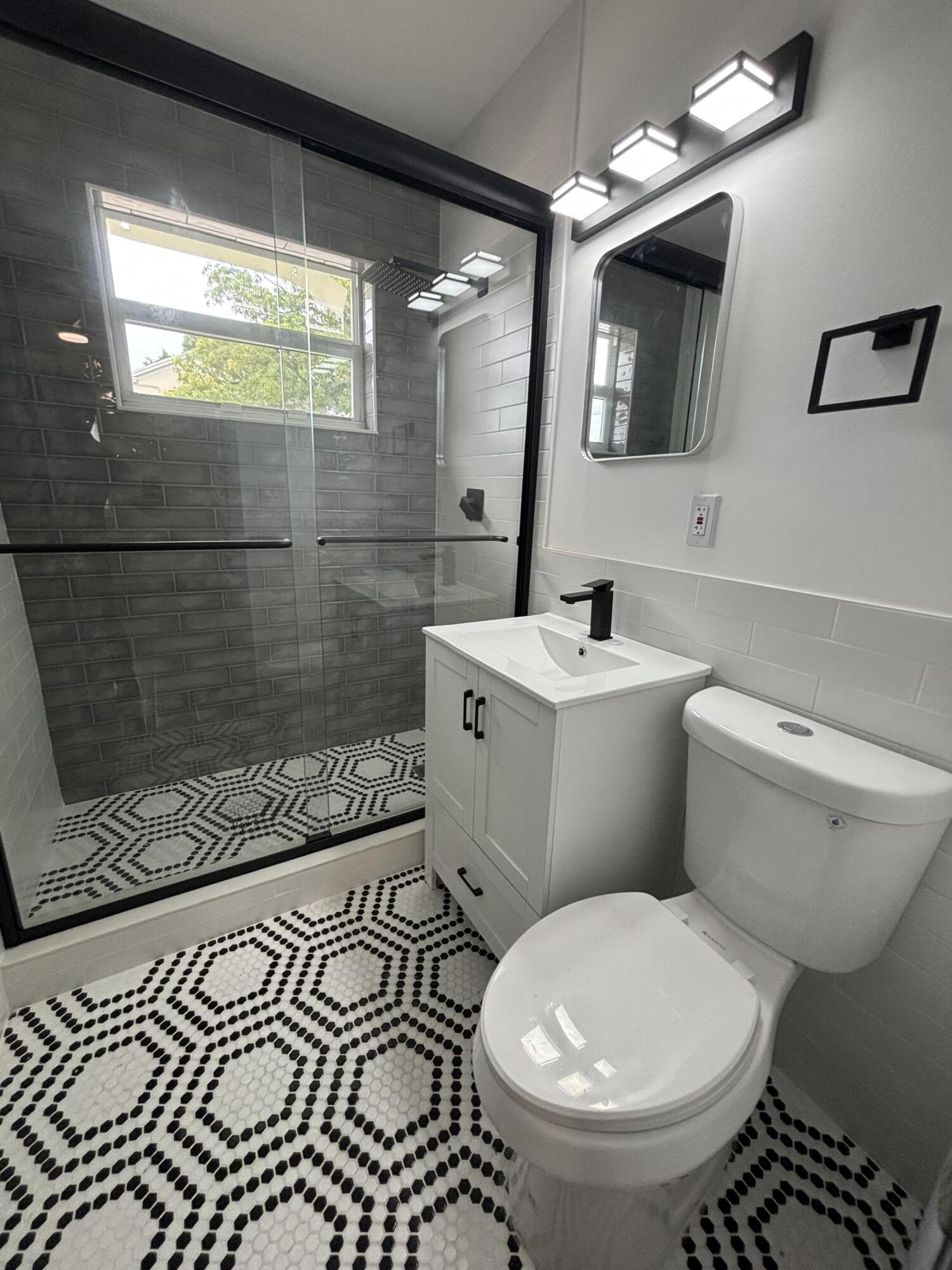 2919 Broadway Avenue, Unit 3 West Palm Beach, FL 33407 - Photo 2 of 6 a bathroom with a sink toilet and shower