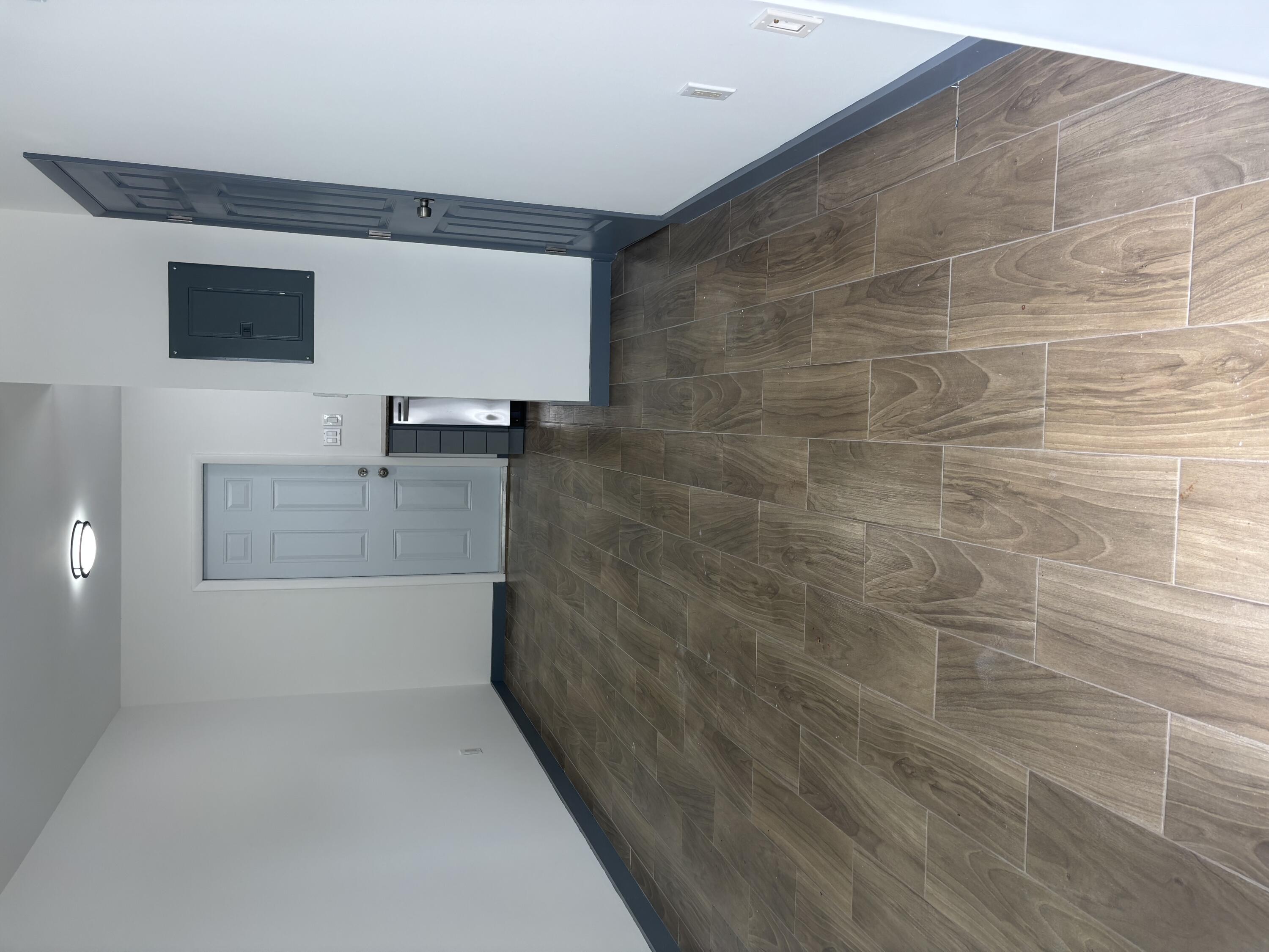 2919 Broadway Avenue, Unit 3 West Palm Beach, FL 33407 - Photo 6 of 6 a bathroom with a granite countertop sink and a mirror