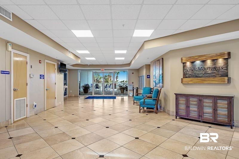 27800 Canal Road, Unit 411 Orange Beach, AL 36561 - Photo 42 of 49 Spacious lobby featuring large format tile flooring with contrasting accent tiles, recessed ceiling lighting, and glass double doors to the exterior