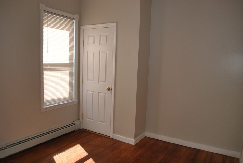 40 I Street, Unit 3 Boston, MA 02127 - Photo 9 of 11 an empty room with wooden floor and windows