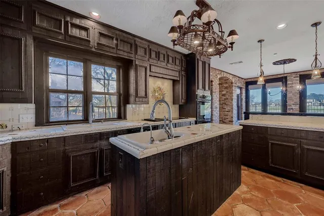 a kitchen with a sink stove and cabinets