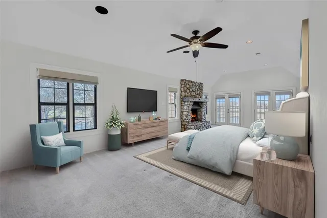 a bedroom with furniture and a flat screen tv