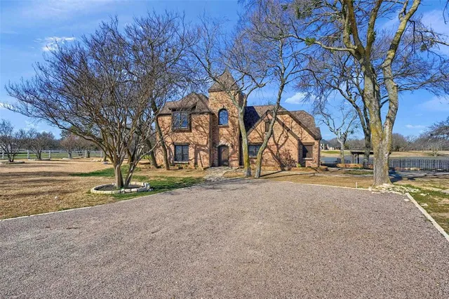 a view of a wooden house with large trees