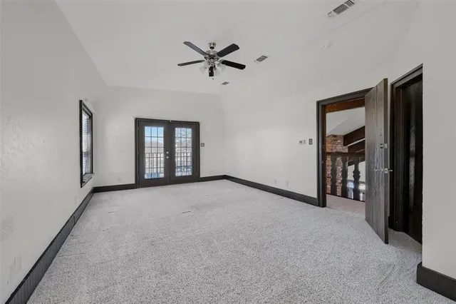 a view of a livingroom with a ceiling fan and window