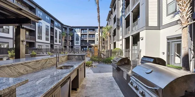 a large living room with lots of furniture and large windows