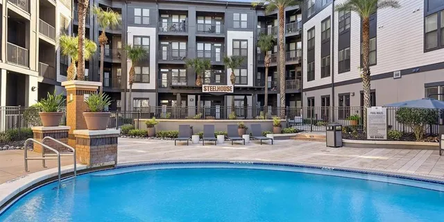 a swimming pool with outdoor seating and yard